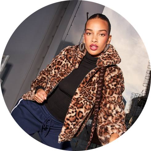 Woman posing in a leopard print jacket