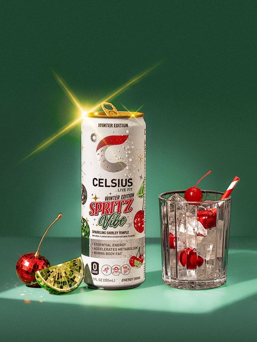 A can of CELSIUS Sparkling Winter Spritz is displayed next to a glass of it against a green background